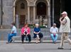 People on bench, Milan, Italy. by Dave Hall